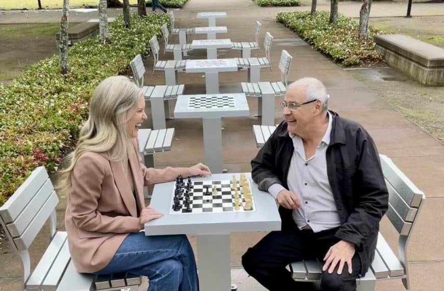 Councillor Nicole Jonic takes on Springfield Ipswich Chess Club’s Ed Cubilla for the inaugural match at newly installed outdoor chess tables.